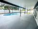 A screened-in outdoor pool is enhanced by a large patio and privacy fence at 1415 Harnden W Rd, Port Orange, FL 32129