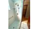 This classic shower features a handheld shower head, safety bar, and blue and white tile at 1415 Harnden W Rd, Port Orange, FL 32129