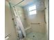 Classic-style shower with handheld shower head, safety bars, and a built-in bench at 1415 Harnden W Rd, Port Orange, FL 32129