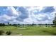 Aerial view of a golf course community with a pond at 1750 Kingfisher Ct, The Villages, FL 32162