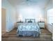 Spacious bedroom with queen bed, light wood floors, and lots of natural light at 1750 Kingfisher Ct, The Villages, FL 32162