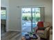 Living room with sliding glass doors leading to a patio and golf course view at 1750 Kingfisher Ct, The Villages, FL 32162