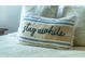 Close-up of decorative pillow with text Stay Awhile at 1750 Kingfisher Ct, The Villages, FL 32162