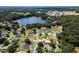 Aerial view of house near a lake in a residential area at 209 Shannon Ln, Lady Lake, FL 32159