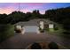 House exterior at dusk, featuring a brick driveway at 209 Shannon Ln, Lady Lake, FL 32159