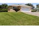 One-story house with a white garage door and well-manicured lawn at 209 Shannon Ln, Lady Lake, FL 32159