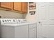 Bright laundry room with washer, dryer, and cabinets at 209 Shannon Ln, Lady Lake, FL 32159