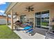 Covered back patio area with ceiling fans, and outdoor dining set at 4947 Ne 124Th Rd, Oxford, FL 34484