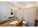 Bathroom featuring wood vanity with granite countertop and a floral shower curtain at 4947 Ne 124Th Rd, Oxford, FL 34484