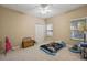 Comfortable bedroom with neutral walls, ceiling fan, closet, and window with blinds at 4947 Ne 124Th Rd, Oxford, FL 34484