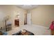 Bedroom showing doorway to bathroom and hallway, neutral walls and carpet at 4947 Ne 124Th Rd, Oxford, FL 34484