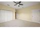 Spacious bedroom with neutral walls, plush carpet, and ample closet space at 4947 Ne 124Th Rd, Oxford, FL 34484