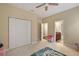 Bedroom showcasing bi-fold closet doors and doorway to an en-suite bath at 4947 Ne 124Th Rd, Oxford, FL 34484