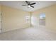 Neutral-colored bedroom with ceiling fan, carpet, and lots of natural light at 4947 Ne 124Th Rd, Oxford, FL 34484