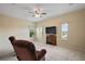 Spacious bonus room featuring neutral walls, plush carpet, and a charming fireplace at 4947 Ne 124Th Rd, Oxford, FL 34484