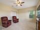 Bonus room with neutral walls, plush carpet, ceiling fan, and natural light at 4947 Ne 124Th Rd, Oxford, FL 34484