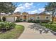 Home exterior with well-manicured landscaping and a curved driveway at 4947 Ne 124Th Rd, Oxford, FL 34484