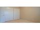 Bedroom with double-door closet and neutral walls at 2075 Grafton Ave, Clermont, FL 34711