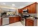 Updated kitchen featuring stainless steel appliances and wood cabinets at 410 Ainsworth Cir, The Villages, FL 32162
