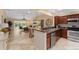 Open kitchen with a breakfast bar overlooking the living room at 410 Ainsworth Cir, The Villages, FL 32162