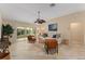 Spacious living room with comfortable seating, large windows, and tiled floors at 410 Ainsworth Cir, The Villages, FL 32162