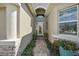 Front entry with a walkway, stone, and potted plants at 8732 Providence Ct, Mount Dora, FL 32757