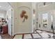 Elegant entryway with tile floors and a decorative wall hanging at 8732 Providence Ct, Mount Dora, FL 32757