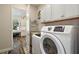 Convenient laundry room with washer, dryer, and storage at 8732 Providence Ct, Mount Dora, FL 32757