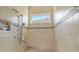 Large walk-in shower with tiled walls and seat at 8732 Providence Ct, Mount Dora, FL 32757