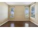 Bedroom with dark wood floors and golf course view at 34416 Tuscany Ave, Sorrento, FL 32776