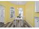 Charming breakfast nook with yellow walls and white table at 5701 Blanchard Ln, The Villages, FL 32163