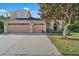Charming two-story home featuring a three-car garage, mature trees, and meticulously maintained landscaping at 13129 Coldwater Loop, Clermont, FL 34711
