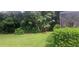 Lush backyard with mature trees and manicured shrubs providing a serene setting at 2602 Tryon Pl, Windermere, FL 34786