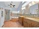 Spacious primary bathroom features double sinks, a walk-in shower, and a soaking tub with tile accents at 2602 Tryon Pl, Windermere, FL 34786