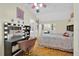 Bright bedroom featuring wood floors, vanity, makeup mirror, and a ceiling fan with pink accents at 2602 Tryon Pl, Windermere, FL 34786