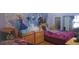 Whimsical ' bedroom with 'Frozen' themed decor, twin beds, and plenty of storage at 2602 Tryon Pl, Windermere, FL 34786