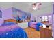 bedroom featuring two beds, wood floors, and a wall mural with colorful accents at 2602 Tryon Pl, Windermere, FL 34786