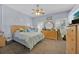 Cozy bedroom with soft blue walls, plush carpeting, and a comfortable bed at 2602 Tryon Pl, Windermere, FL 34786
