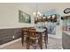 Dining area featuring wood-look accent wall and large window at 2602 Tryon Pl, Windermere, FL 34786