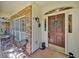 Inviting front porch with brick flooring, a decorative wreath on the door, and comfortable seating area at 2602 Tryon Pl, Windermere, FL 34786