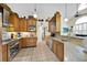 Spacious kitchen features stainless appliances, granite counters and light wood cabinetry at 2602 Tryon Pl, Windermere, FL 34786