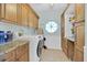 Well-lit laundry room with washer, dryer, and ample cabinet space at 2602 Tryon Pl, Windermere, FL 34786