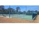 A fenced tennis court ready for matches and recreation with lighting for evening play at 2602 Tryon Pl, Windermere, FL 34786