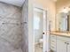 Bathroom with tiled shower, toilet, and vanity at 2673 Beckett Run, The Villages, FL 32162