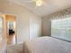 Bedroom with vaulted ceiling, ceiling fan and large window at 2673 Beckett Run, The Villages, FL 32162