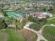 Aerial view of community amenities including tennis courts, clubhouse, and pool at 2673 Beckett Run, The Villages, FL 32162