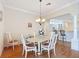 Formal dining room with hardwood floors and a view to the kitchen at 2673 Beckett Run, The Villages, FL 32162