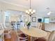 Elegant dining room adjacent to kitchen, hardwood floors, and chandelier at 2673 Beckett Run, The Villages, FL 32162