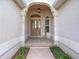 Elegant entryway with arched doorway, stained glass door, and tile flooring at 2673 Beckett Run, The Villages, FL 32162