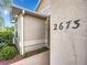 House exterior view of the front entrance with stucco siding and walkway at 2673 Beckett Run, The Villages, FL 32162